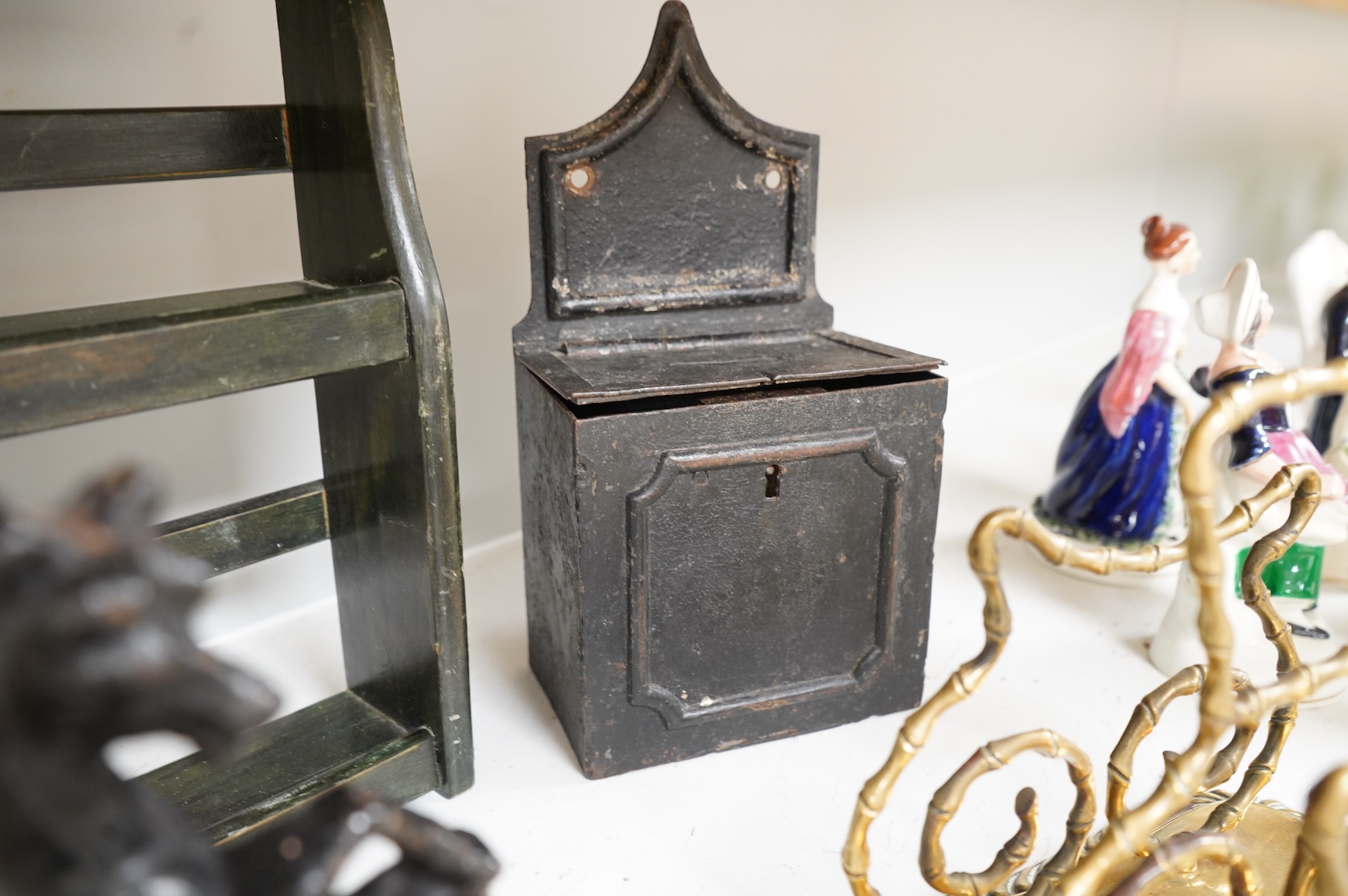 Sundry items to include an iron money box, brass letter rack, horse door stop and a 19th century oak carving, largest 32cm high